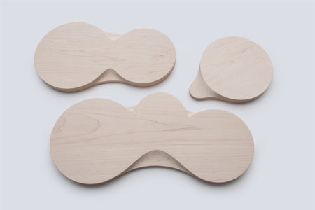 Loops is a series of wood multi-purpose cutting boards and trays with a playful form