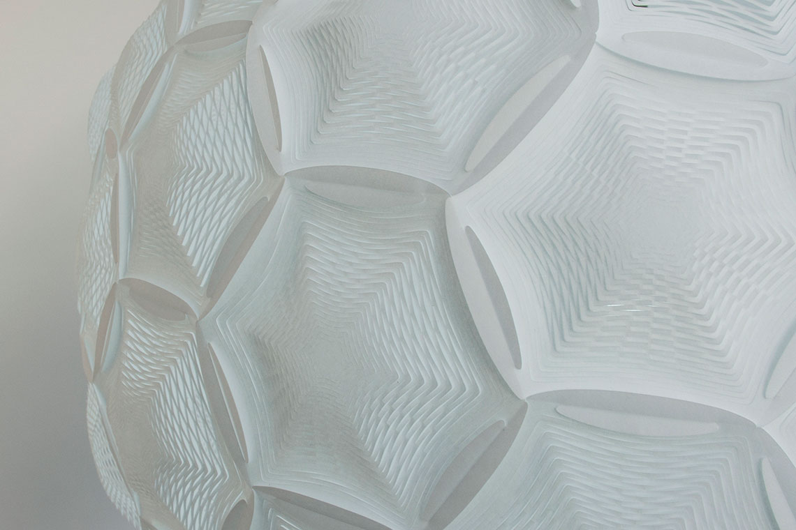 Airy Sphere Pendant white rice paper lamp zoom-in detail of interlocking hexagon and pentagon perforated panels