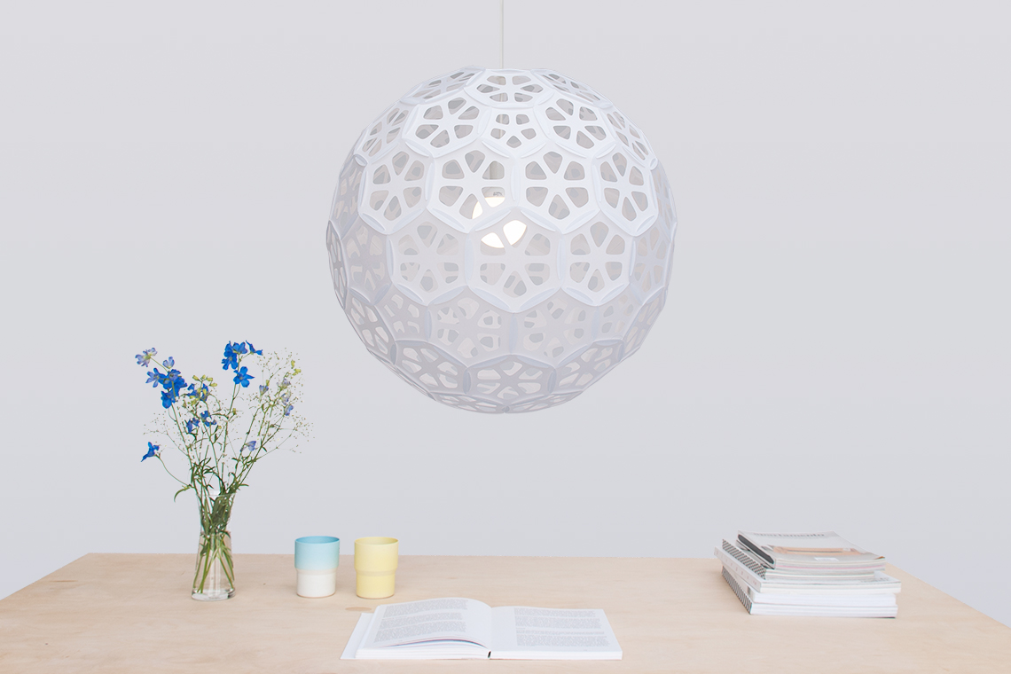 Very large white flower patterned sphere pendant lamp over dining table designed by 24d-studio in Japan.