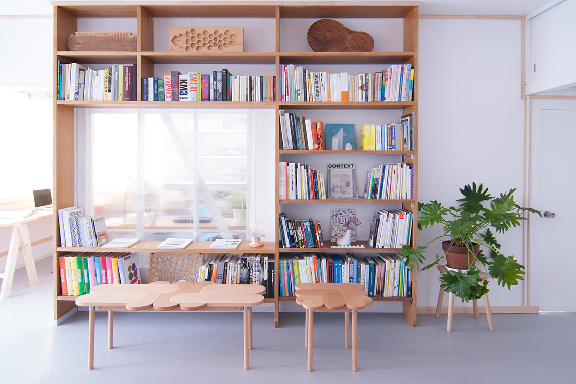 Kobe Studio view of main studio and restored wood built-in shelf with 24d-studio designed Moku+ furniture set.