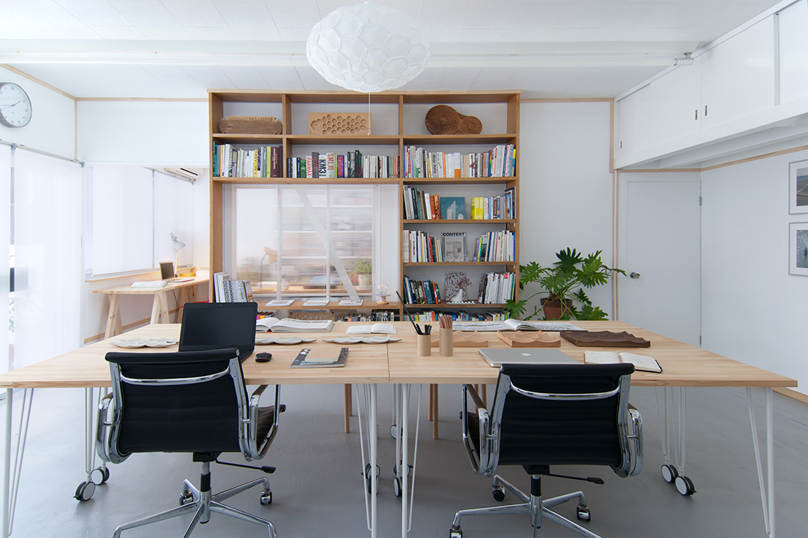 Kobe Studio view of main studio with built-in shelves and mobile desks.