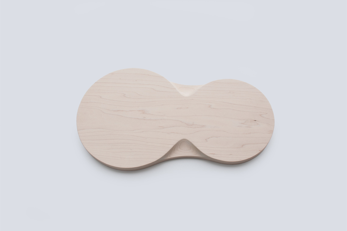 Loops medium tray sculptural grip detail is carved into solid maple wood.