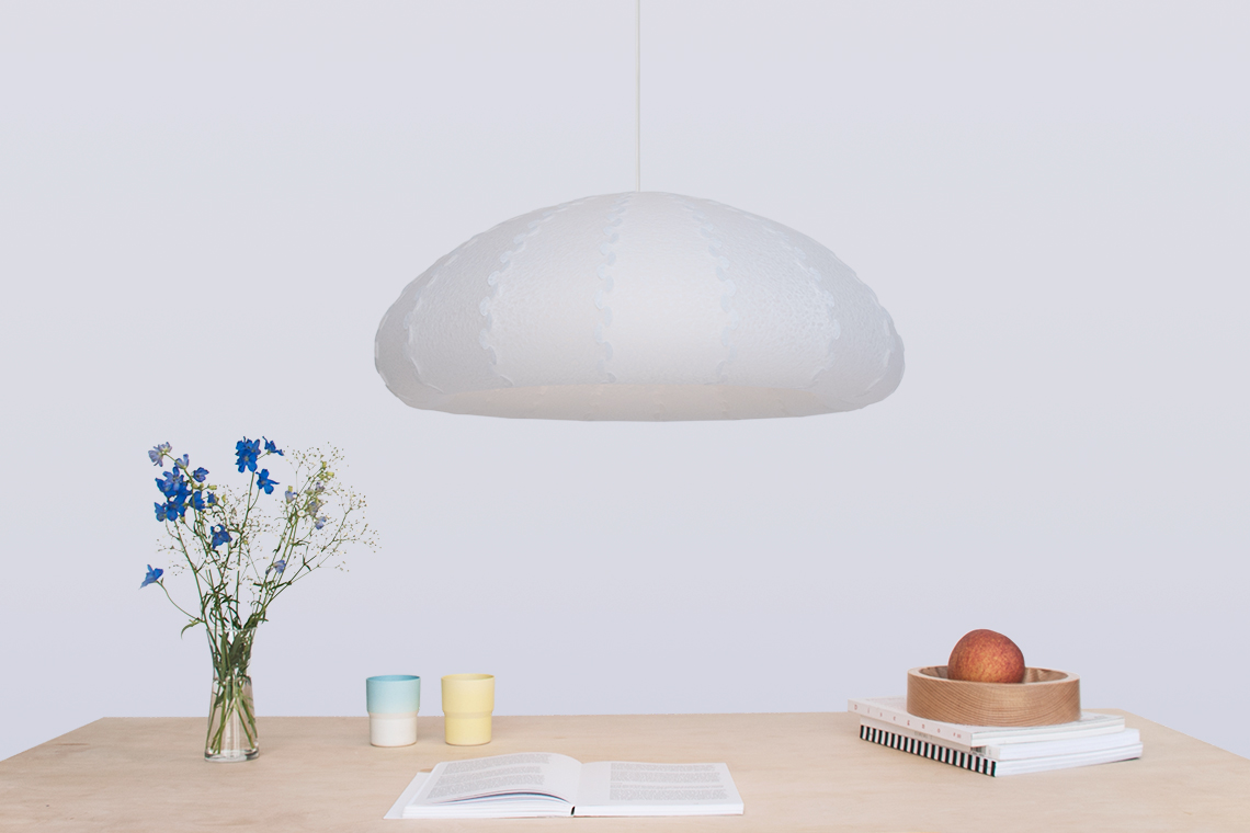 Puff Large white bell shaped pendant light over dining table designed by 24d-studio in Japan.