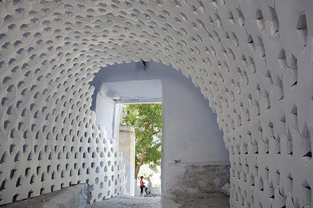 Daphneインスタレーション風景。自立した紙のアーチパネルがギリシャ・サントリーニ島のトンネル空間を包む。